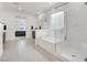 Elegant bathroom featuring a soaking tub, walk-in shower, and bright natural light at 6261 Lamont Hills Ave, Las Vegas, NV 89139