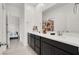 Bright bathroom featuring double sinks, modern fixtures, and a view into the connected bedroom at 6261 Lamont Hills Ave, Las Vegas, NV 89139