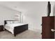 Clean bedroom with a bed and dark-stained end table at 6261 Lamont Hills Ave, Las Vegas, NV 89139