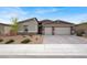 Attractive single-story home with a three-car garage and desert landscaping at 6261 Lamont Hills Ave, Las Vegas, NV 89139