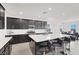 Bright kitchen featuring a large island with bar stools, modern appliances, and plenty of counter space at 6261 Lamont Hills Ave, Las Vegas, NV 89139