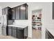 Kitchen showing stainless steel refrigerator and cabinets with a view into the walk-in pantry at 6261 Lamont Hills Ave, Las Vegas, NV 89139