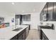 Modern kitchen with a large island, stainless steel appliances, and sleek black cabinetry at 6261 Lamont Hills Ave, Las Vegas, NV 89139