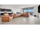 Open-concept living room with a modern kitchen, large seating, and an open patio at 6261 Lamont Hills Ave, Las Vegas, NV 89139