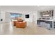 Bright living room with comfortable leather seating, large windows, and a stylish wet bar at 6261 Lamont Hills Ave, Las Vegas, NV 89139