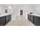 Bright bathroom featuring double sinks, black cabinets and a separate shower and toilet room at 6261 Lamont Hills Ave, Las Vegas, NV 89139
