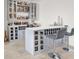 Stylish wet bar with custom cabinetry, wine storage, and seating at 6261 Lamont Hills Ave, Las Vegas, NV 89139