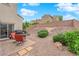 Backyard patio with seating area, barbecue, and desert landscaping at 6647 Rego Park Ct, Las Vegas, NV 89166