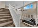 Open room with stairs to second level, carpet, high ceilings, ceiling fan, and natural light at 6647 Rego Park Ct, Las Vegas, NV 89166