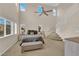 Bright bedroom with many windows, high ceilings, carpet, ceiling fan and staircase at 6647 Rego Park Ct, Las Vegas, NV 89166
