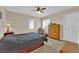 Cozy bedroom with a ceiling fan, window blinds, and a wooden dresser at 6647 Rego Park Ct, Las Vegas, NV 89166