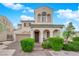 Charming home featuring arched entryway, well-manicured landscaping, and a two-car garage at 6647 Rego Park Ct, Las Vegas, NV 89166
