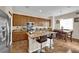 Eat-in kitchen features granite counters, stainless steel appliances, and breakfast bar seating at 6647 Rego Park Ct, Las Vegas, NV 89166