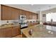 Well-equipped kitchen with stainless appliances, granite countertops, and wood cabinetry at 6647 Rego Park Ct, Las Vegas, NV 89166