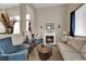 Cozy living room with fireplace, neutral decor, and comfortable seating arrangement at 6647 Rego Park Ct, Las Vegas, NV 89166