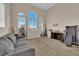 Bright living room with large windows and a comfortable gray couch at 6647 Rego Park Ct, Las Vegas, NV 89166