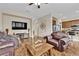 Cozy living room showcases wood floors, kitchen access, and comfortable seating at 6647 Rego Park Ct, Las Vegas, NV 89166
