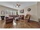 Spacious living room with hardwood floors, ceiling fan, and large leather sectional at 6647 Rego Park Ct, Las Vegas, NV 89166