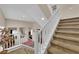 Carpeted staircase with white railing and natural light showcases the home's architecture at 6647 Rego Park Ct, Las Vegas, NV 89166