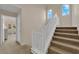 Carpeted stairs with white railing leading to the upper level with ample light at 6647 Rego Park Ct, Las Vegas, NV 89166