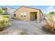 A spacious backyard featuring desert landscaping, a covered patio, and a view of the property's exterior at 6856 Council Heights Way, Las Vegas, NV 89142