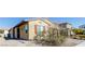 Side angle of tan single-story home with brown shutters, desert landscaping, and natural light at 6856 Council Heights Way, Las Vegas, NV 89142