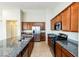 A modern kitchen features stainless steel appliances, granite countertops, and ample cabinet space at 6856 Council Heights Way, Las Vegas, NV 89142