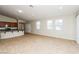 Spacious living room with tile floors, bright windows, and open layout to the kitchen area at 6856 Council Heights Way, Las Vegas, NV 89142