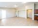 Spacious open-concept living area with neutral tones, sliding glass doors and a tile floor at 6856 Council Heights Way, Las Vegas, NV 89142
