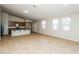 Bright open concept with kitchen, living, and dining areas filled with tile floors and natural lighting at 6856 Council Heights Way, Las Vegas, NV 89142