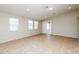 Open living room with tile floors, recessed lighting, and sliding glass doors for natural light at 6856 Council Heights Way, Las Vegas, NV 89142