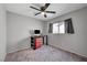 Bedroom featuring neutral walls, a ceiling fan, window, and a desk area at 687 Porchtown Ave, Las Vegas, NV 89183