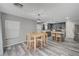 Open-concept dining area with wood floors, and view of the kitchen at 687 Porchtown Ave, Las Vegas, NV 89183