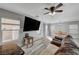Bright living room with wood flooring, large TV, and comfortable leather sofa at 687 Porchtown Ave, Las Vegas, NV 89183