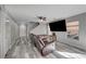 Open-concept living area with wood floors, a leather sofa, and natural light at 687 Porchtown Ave, Las Vegas, NV 89183