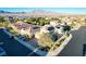 Stunning aerial view of a modern home featuring a well-maintained lawn, solar panels, and mountain views at 8136 Canyon Grassland St, Las Vegas, NV 89166