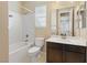 Bathroom featuring a shower/tub combination with white tile and a vanity with mirror at 8136 Canyon Grassland St, Las Vegas, NV 89166