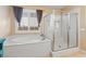 Bright bathroom featuring a soaking tub and glass-enclosed shower with seat at 8136 Canyon Grassland St, Las Vegas, NV 89166