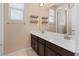 Bathroom featuring double sinks, dark wood cabinetry, and a large mirror at 8136 Canyon Grassland St, Las Vegas, NV 89166
