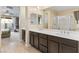 Bathroom featuring a double sink vanity, wood-look tile floor, and shower at 8136 Canyon Grassland St, Las Vegas, NV 89166