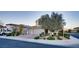 Inviting two-story house with a three-car garage, lush landscaping, and a well-kept lawn at 8136 Canyon Grassland St, Las Vegas, NV 89166