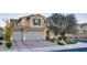 Attractive two-story home with a three-car garage, complemented by well-maintained landscaping at 8136 Canyon Grassland St, Las Vegas, NV 89166