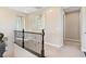 Upstairs hallway with decorative railings and neutral colored walls at 8136 Canyon Grassland St, Las Vegas, NV 89166