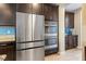 Modern kitchen featuring stainless steel appliances, dark wood cabinets, and a built-in oven at 8136 Canyon Grassland St, Las Vegas, NV 89166