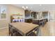 Spacious kitchen with a large island, dark wood cabinets, and open access to the dining area at 8136 Canyon Grassland St, Las Vegas, NV 89166