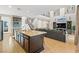 Open-concept kitchen featuring a large island, stainless appliances, and seamless flow into the living area at 8136 Canyon Grassland St, Las Vegas, NV 89166