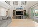 Spacious living room featuring tile floors, entertainment center, and sliding glass doors to the backyard at 8136 Canyon Grassland St, Las Vegas, NV 89166