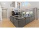 Living room with high ceilings, modern décor, and a large sectional sofa, leading to outdoor patio area at 8136 Canyon Grassland St, Las Vegas, NV 89166