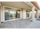 Spacious outdoor patio with seamless indoor-outdoor flow through large sliding glass doors and refined stone pavers at 8136 Canyon Grassland St, Las Vegas, NV 89166
