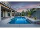 Backyard pool with waterfall feature, palm trees, and patio at 8136 Canyon Grassland St, Las Vegas, NV 89166